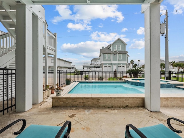 1250 Oahu Dr, Tiki Island, TX 77554 - view of swimming pool featuring a fenced backyard, a pool with connected hot tub, a patio area, and stairway
