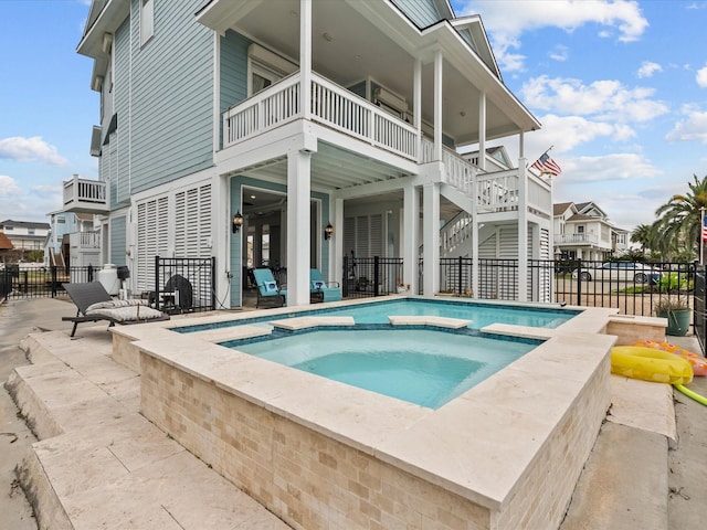 1250 Oahu Dr, Tiki Island, TX 77554 - view of swimming pool with a patio, a residential view, fence, and a pool with connected hot tub