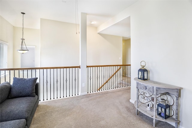 corridor featuring carpet flooring and an upstairs landing