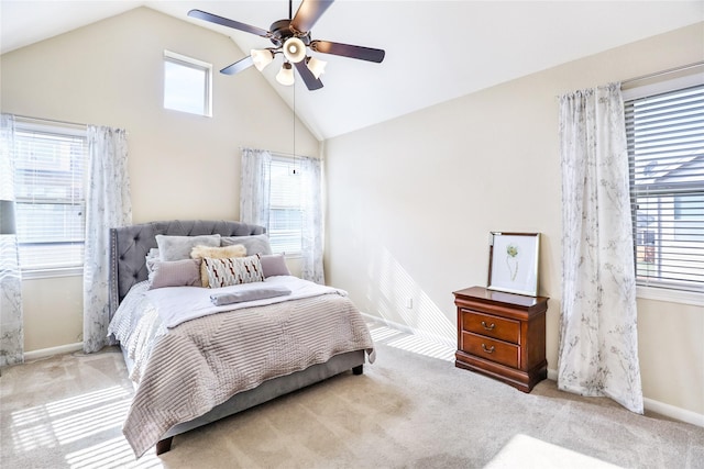 bedroom with high vaulted ceiling, ceiling fan, baseboards, and light colored carpet