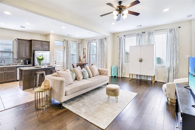 living area with dark wood-style floors, visible vents, and recessed lighting