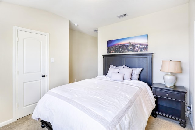 bedroom featuring baseboards, visible vents, and light colored carpet