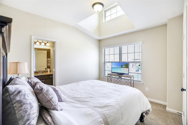 bedroom with ensuite bathroom, light carpet, a sink, baseboards, and vaulted ceiling