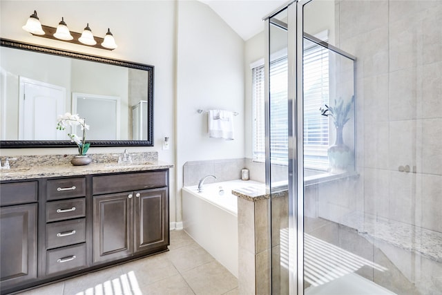 full bathroom featuring double vanity, tile patterned flooring, a shower stall, and a sink