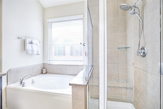 full bathroom featuring a garden tub and a shower stall