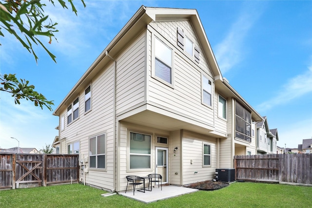 back of property with a yard, central AC unit, a patio area, and fence