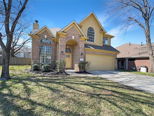 traditional-style house featuring brick siding, a chimney, concrete driveway, a front yard, and fence