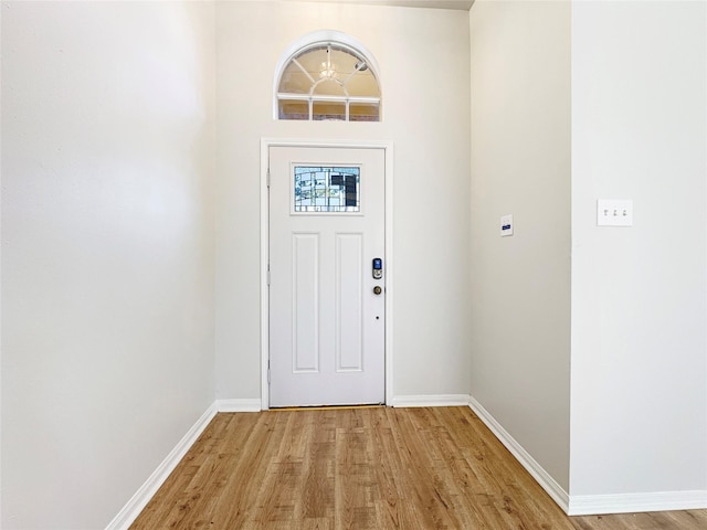 entryway with baseboards and light wood-style floors