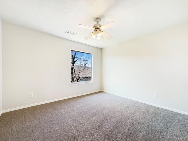 empty room featuring a ceiling fan, carpet, visible vents, and baseboards