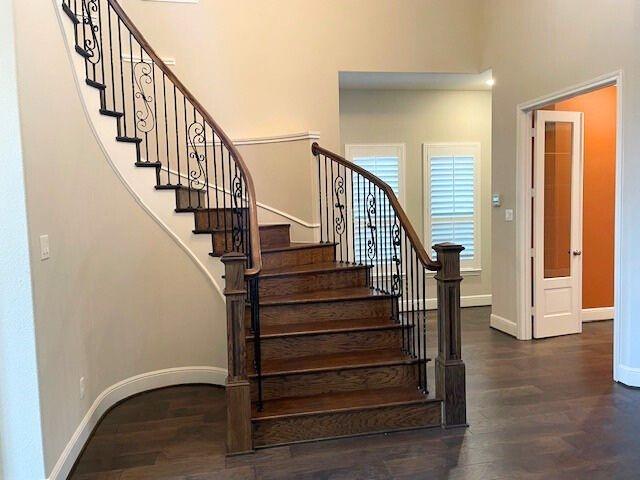 stairs with baseboards and wood finished floors