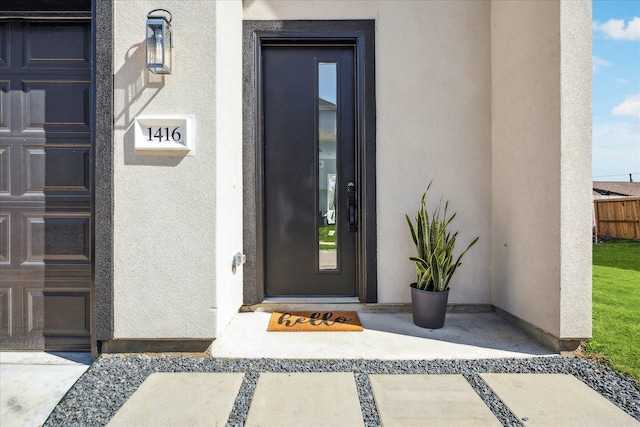 view of exterior entry featuring stucco siding