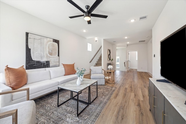 living room with recessed lighting, visible vents, ceiling fan, wood finished floors, and stairs