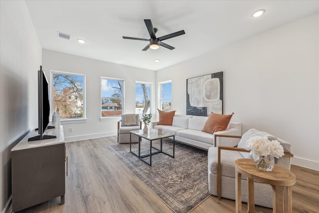 living room with visible vents, plenty of natural light, and light wood-style flooring