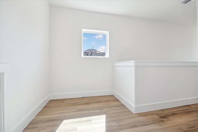 empty room with light wood-style floors and baseboards