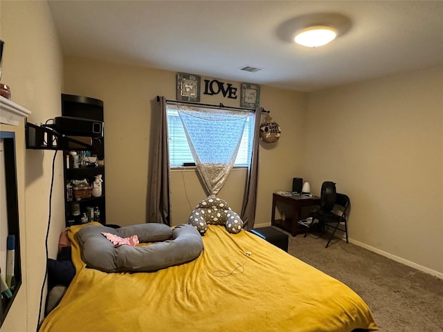 carpeted bedroom with visible vents and baseboards