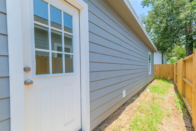 entrance to property featuring fence