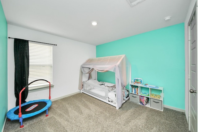 carpeted bedroom with visible vents and baseboards