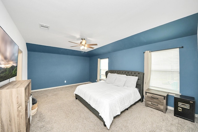 carpeted bedroom featuring baseboards, visible vents, and ceiling fan