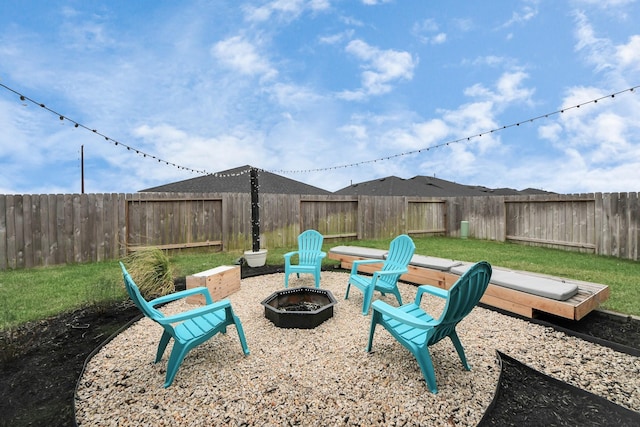 view of yard with a fire pit and a fenced backyard