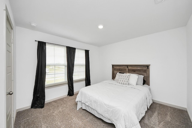 bedroom featuring carpet floors and baseboards