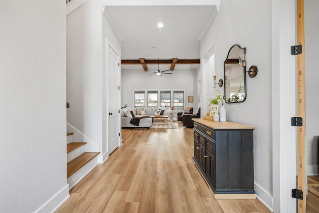 corridor with light wood-style floors, stairs, baseboards, and beamed ceiling