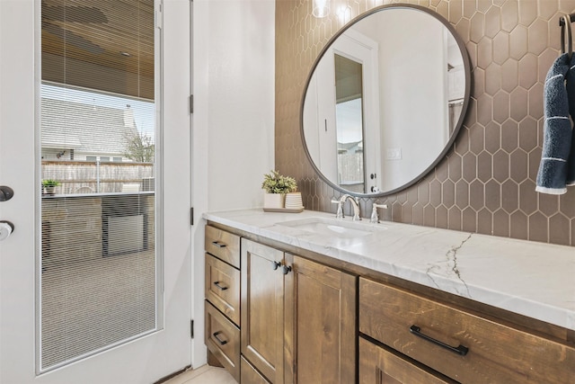 bathroom featuring tasteful backsplash and vanity