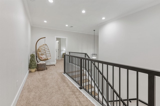 hall featuring recessed lighting, light colored carpet, ornamental molding, an upstairs landing, and baseboards