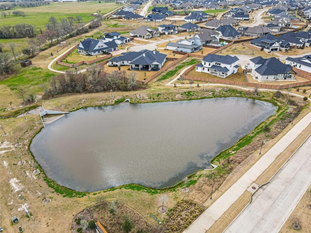 birds eye view of property with a water view and a residential view