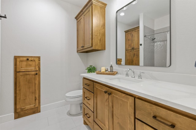 bathroom with toilet, vanity, baseboards, a shower, and tile patterned floors