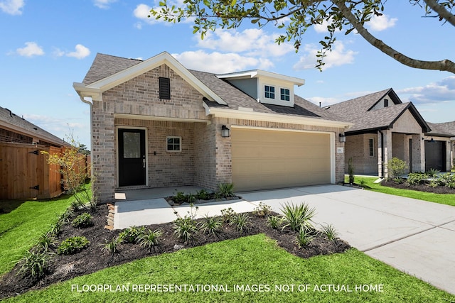 view of front of property featuring brick siding, roof with shingles, a front yard, a garage, and driveway