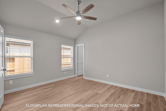 empty room featuring light wood-type flooring, ceiling fan, lofted ceiling, and baseboards