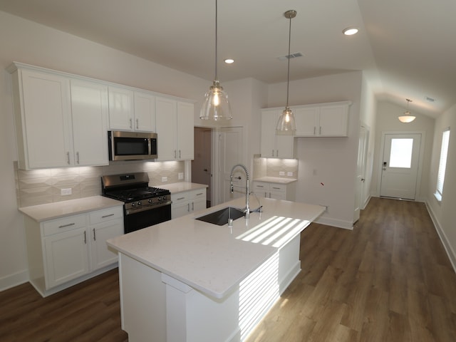 21659 Wave Hollow Dr, Cypress, TX 77433 - kitchen featuring stainless steel appliances, a sink, decorative backsplash, white cabinets, and lofted ceiling