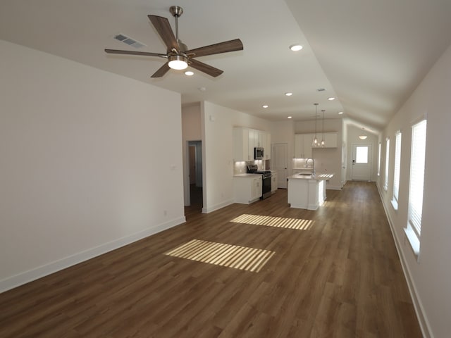21659 Wave Hollow Dr, Cypress, TX 77433 - unfurnished living room with recessed lighting, baseboards, lofted ceiling, dark wood-style floors, and ceiling fan