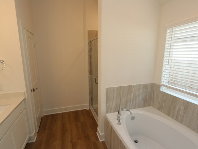 21659 Wave Hollow Dr, Cypress, TX 77433 - bathroom with a stall shower, a garden tub, wood finished floors, and vanity
