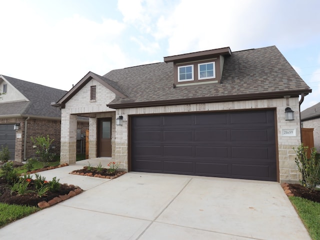 21659 Wave Hollow Dr, Cypress, TX 77433 - view of front of property featuring driveway, an attached garage, roof with shingles, and stone siding