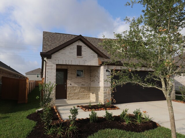 21659 Wave Hollow Dr, Cypress, TX 77433 - view of front of property featuring driveway, roof with shingles, stone siding, and brick siding