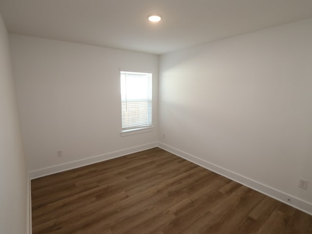 21659 Wave Hollow Dr, Cypress, TX 77433 - spare room with dark wood-style floors and baseboards