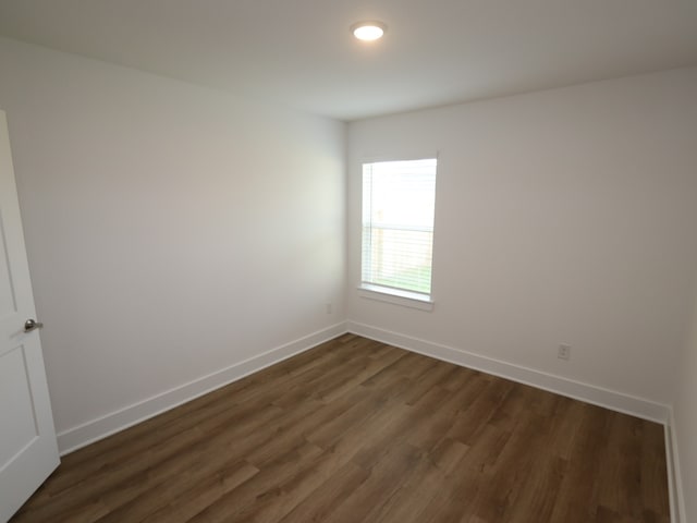 21659 Wave Hollow Dr, Cypress, TX 77433 - spare room with dark wood-style flooring and baseboards