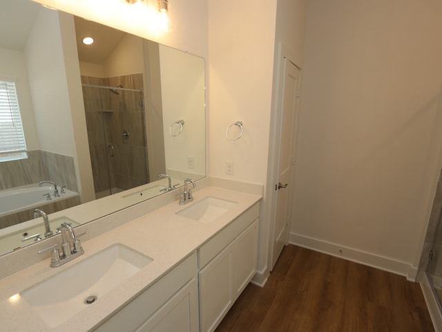 21659 Wave Hollow Dr, Cypress, TX 77433 - full bath featuring a shower stall, a bath, wood finished floors, and double vanity