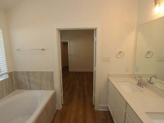 21659 Wave Hollow Dr, Cypress, TX 77433 - full bath with wood finished floors, double vanity, and a garden tub