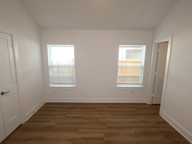 21659 Wave Hollow Dr, Cypress, TX 77433 - empty room with lofted ceiling, healthy amount of natural light, dark wood-type flooring, and baseboards