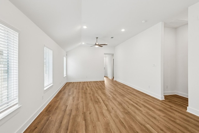 21659 Wave Hollow Dr, Cypress, TX 77433 - unfurnished living room with healthy amount of natural light, light wood-type flooring, lofted ceiling, a ceiling fan, and recessed lighting