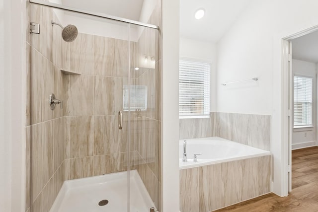 21659 Wave Hollow Dr, Cypress, TX 77433 - full bath featuring a stall shower, a garden tub, healthy amount of natural light, and wood finished floors