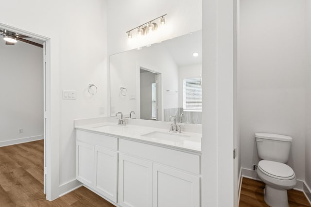21659 Wave Hollow Dr, Cypress, TX 77433 - full bath with double vanity, wood finished floors, and a ceiling fan
