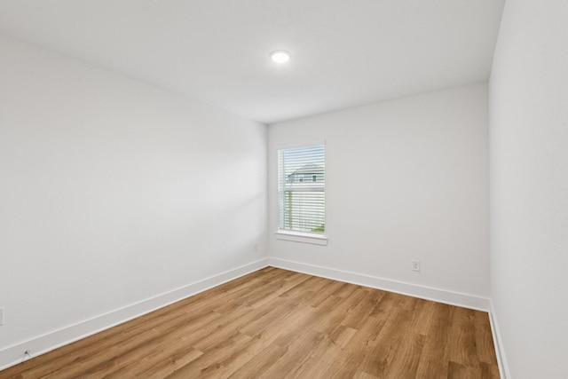 21659 Wave Hollow Dr, Cypress, TX 77433 - unfurnished room with light wood-style floors and baseboards