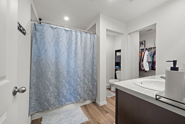 1730 Windstone Ridge Dr, Houston, TX 77014 - full bath with wood finished floors, vanity, a shower with curtain, and a spacious closet