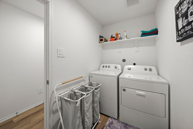 1730 Windstone Ridge Dr, Houston, TX 77014 - laundry area with independent washer and dryer and light wood-type flooring