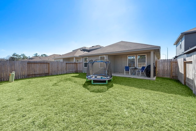 1730 Windstone Ridge Dr, Houston, TX 77014 - back of house featuring a trampoline, a patio area, and a fenced backyard