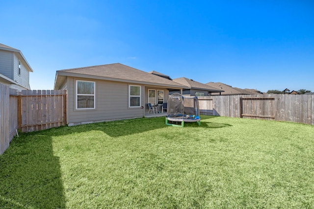 1730 Windstone Ridge Dr, Houston, TX 77014 - rear view of house with a trampoline, a fenced backyard, and roof with shingles