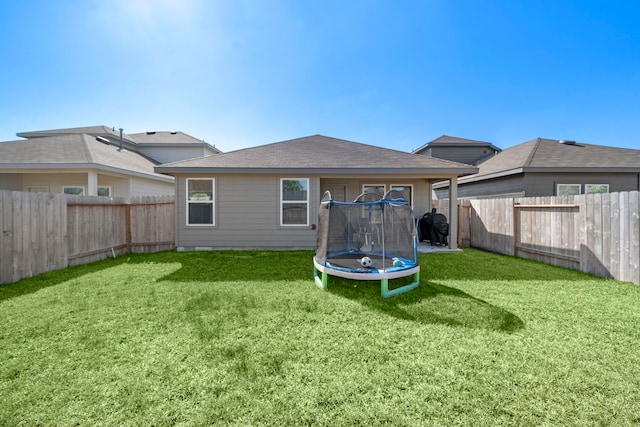 1730 Windstone Ridge Dr, Houston, TX 77014 - rear view of house featuring a trampoline and a fenced backyard